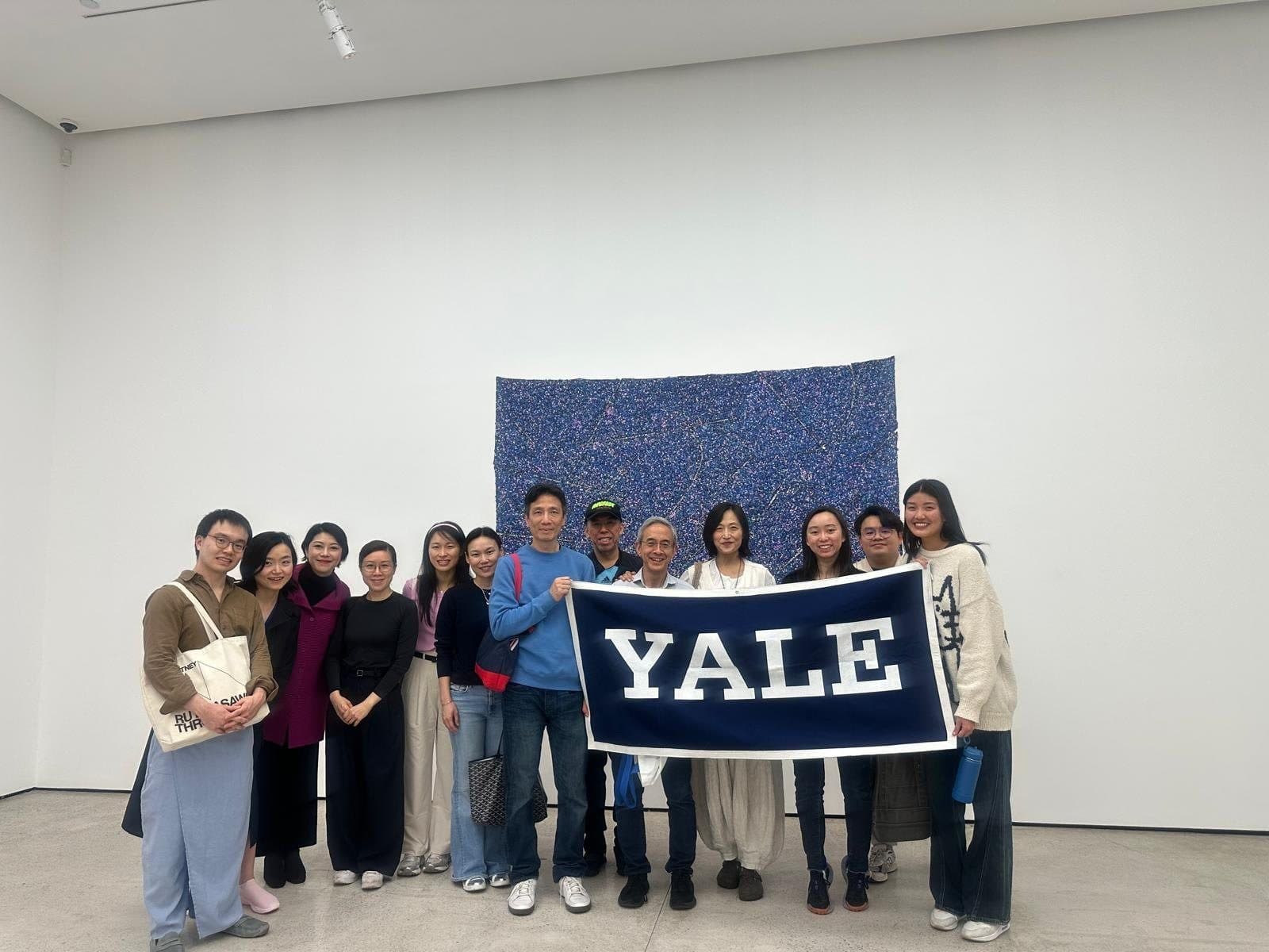 Members with a Yale banner at the White Cube gallery in Hong Kong